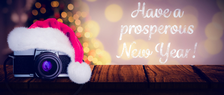 christmas camera against desk with christmas tree in backgroundの写真素材