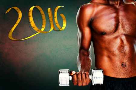 Serious fit shirtless young man lifting dumbbell against dark background