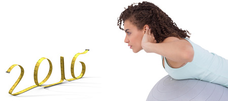 Fit woman wokring out on exercise ball against white background with vignetteの写真素材