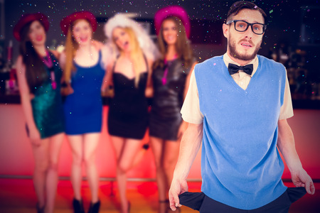 Geeky hipster showing empty pockets against flying coloursの写真素材