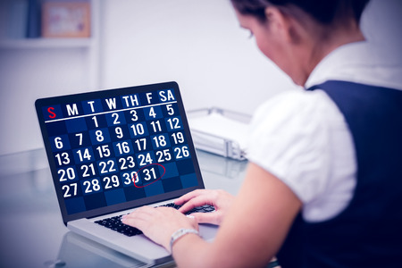 Technology lock screen against businesswoman using laptopの写真素材