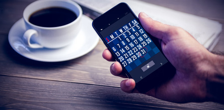 Mobile lock screen against person showing mobile phone at deskの写真素材