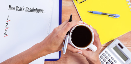 New years resolution list against part of hands taking notes