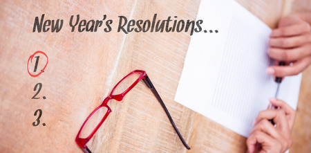 New years resolution list against close up view of a piece of paperの写真素材