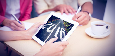 Creative team using tablet pc against 2016 road