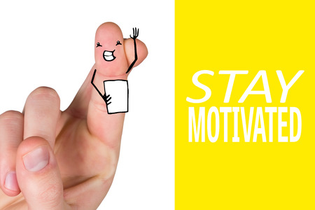 Hand crossing fingers for luck against yellow background with vignetteの写真素材