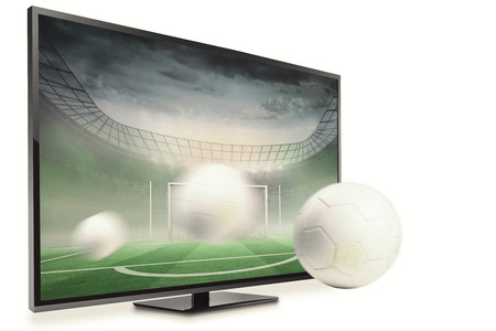 White leather football with grass stains against football pitch in large stadium