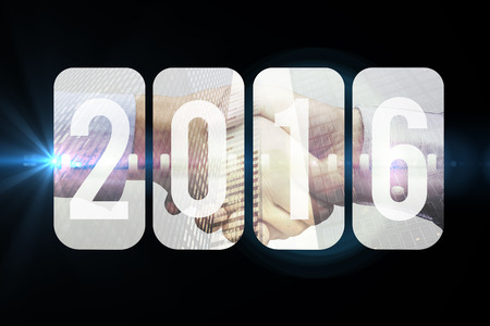 New year graphic against composite image of hand shake in front of wiresの写真素材