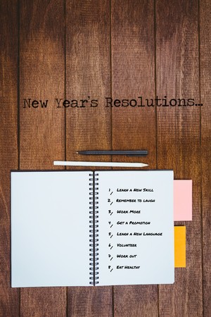 New year resolution list against white background against close up view of a workbookの写真素材