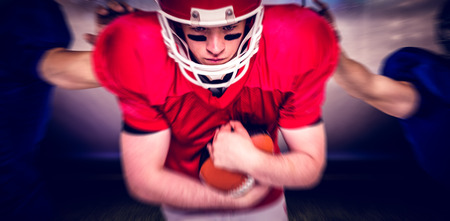 American football players against american football arena