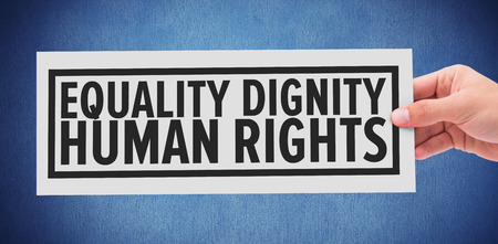 Hand showing card against blue backgroundの写真素材