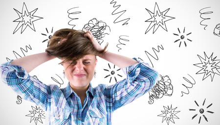 Pretty brunette getting a headache with hands on head against white background with vignetteの写真素材