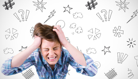 Pretty brunette shouting with hands on head against white background with vignette