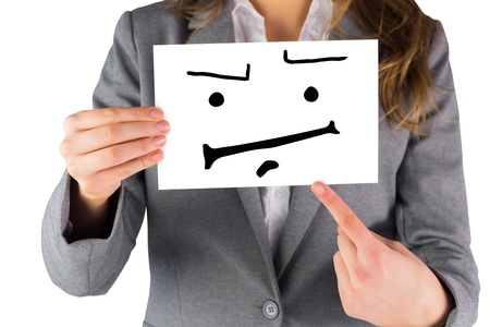 Businesswoman showing a card against white background with vignetteの写真素材