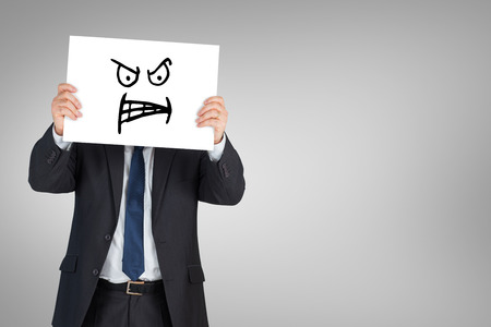 Mature businessman showing card against white background with vignetteの写真素材