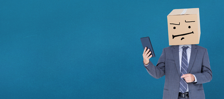 Anonymous businessman against blue backgroundの写真素材