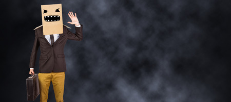 Anonymous businessman against dark backgroundの写真素材