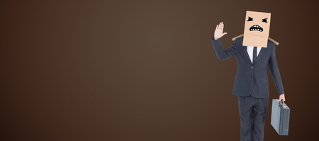 Anonymous businessman against dark brown backgroundの写真素材