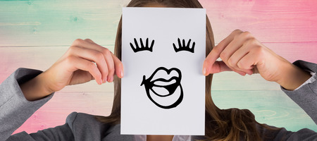 Businesswoman showing a card against pink and green planksの写真素材