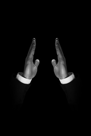 Hand presenting against black