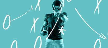American football player pointing at camera against blue vignette background