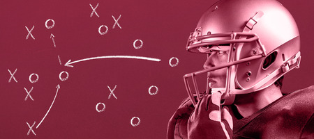 Sportsman wearing helmet looking away against red background