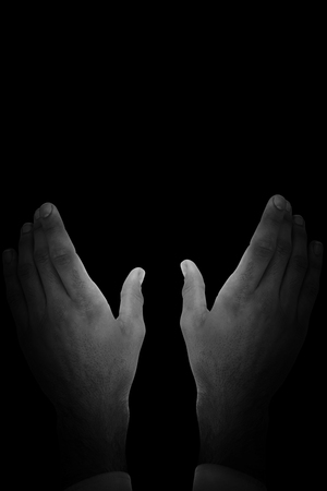 Businessman holding hand out in presentation against blackの写真素材