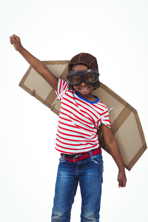 Smiling boy pretending to be pilot on white screenの写真素材