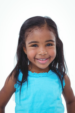 Cute girl smiling at the camera on white screenの写真素材