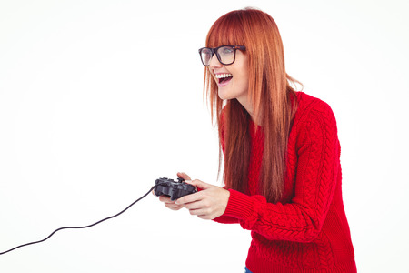 Smiling hipster woman playing video games against white background