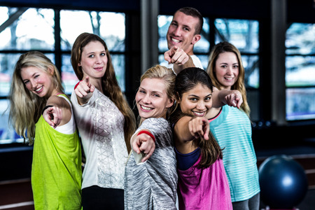 Dancer group pointing the camera in the gym