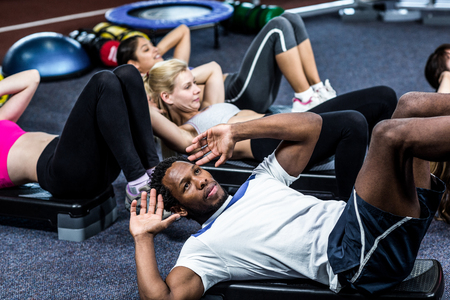 Group of people working their abs in gymの写真素材