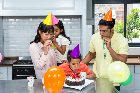 Happy family celebrating a birthday at home in the kitchen