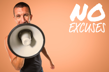 Male trainer yelling through megaphone against orange backgroundの写真素材
