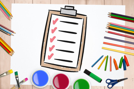 Digitally generated image of paper on clip board against art suppliesの写真素材