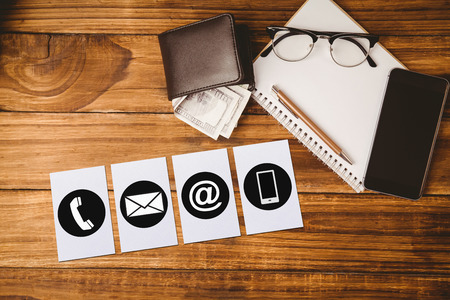 Communication apps against pen and glasses on notepad next to wallet and smartphoneの写真素材