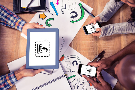 Photography apps against overhead view of creative business people working at deskの写真素材