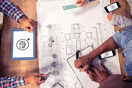Photography apps against overhead view of creative team working on desk