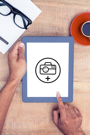 Photography apps against overhead view of person using on digital tabletの写真素材