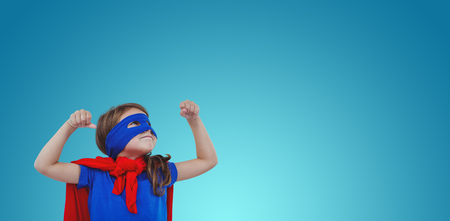 Masked girl pretending to be superhero against purple vignetteの写真素材