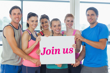 The word join us and portrait of a group of fitness class holding blank paper against modern blue...