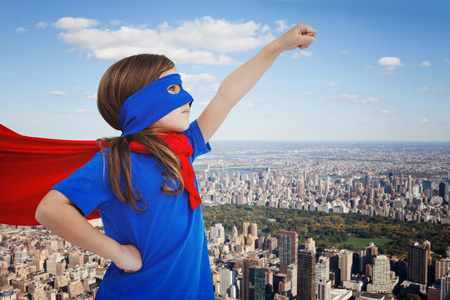 Masked girl pretending to be superhero against new yorkの写真素材