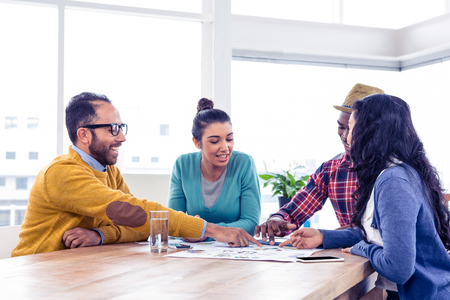 Business team sitting while discussing in meeting at creative officeの写真素材