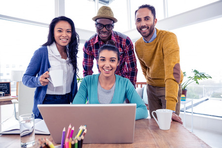 Portrait of cheerful business team at creative office