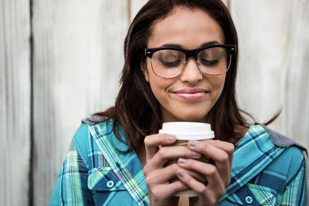 Girl smelling her coffeeの写真素材