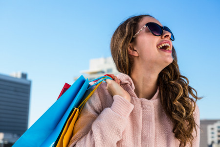 Young girl make shopping laughing in town in a sunny dayの写真素材