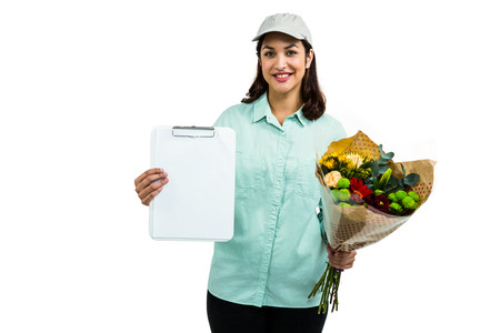 Portrait of cheerful delivery woman with flower bouquet against white background