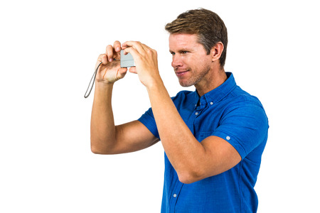 Man photographing with camera against white background