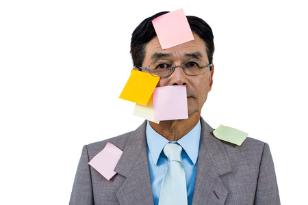 Businessman with blank note over his face on white backgroundの写真素材
