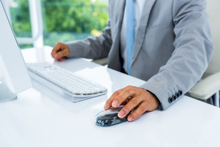 Businessman using his computer in an officeの写真素材